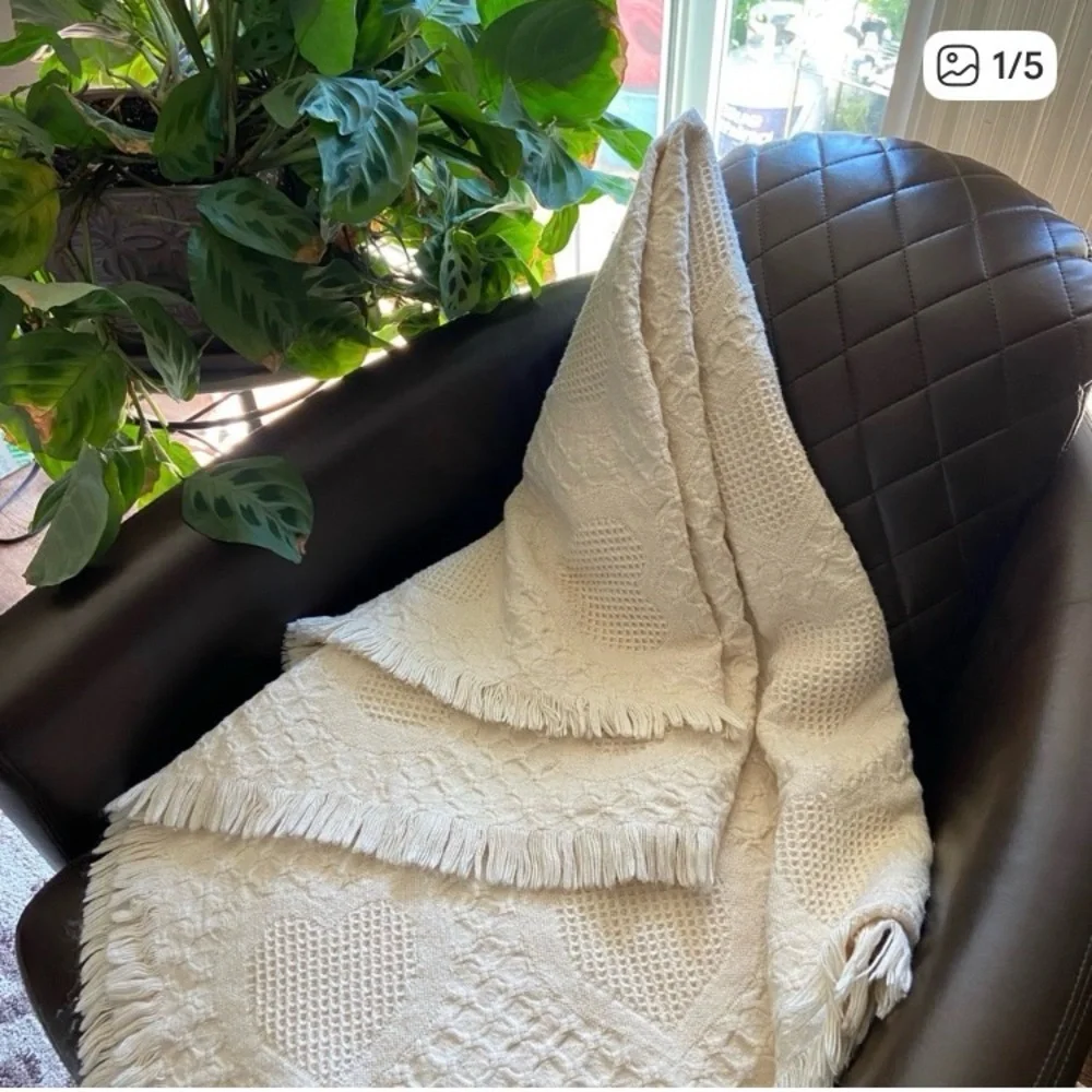 Beautiful white blanket with subtle heart detail.